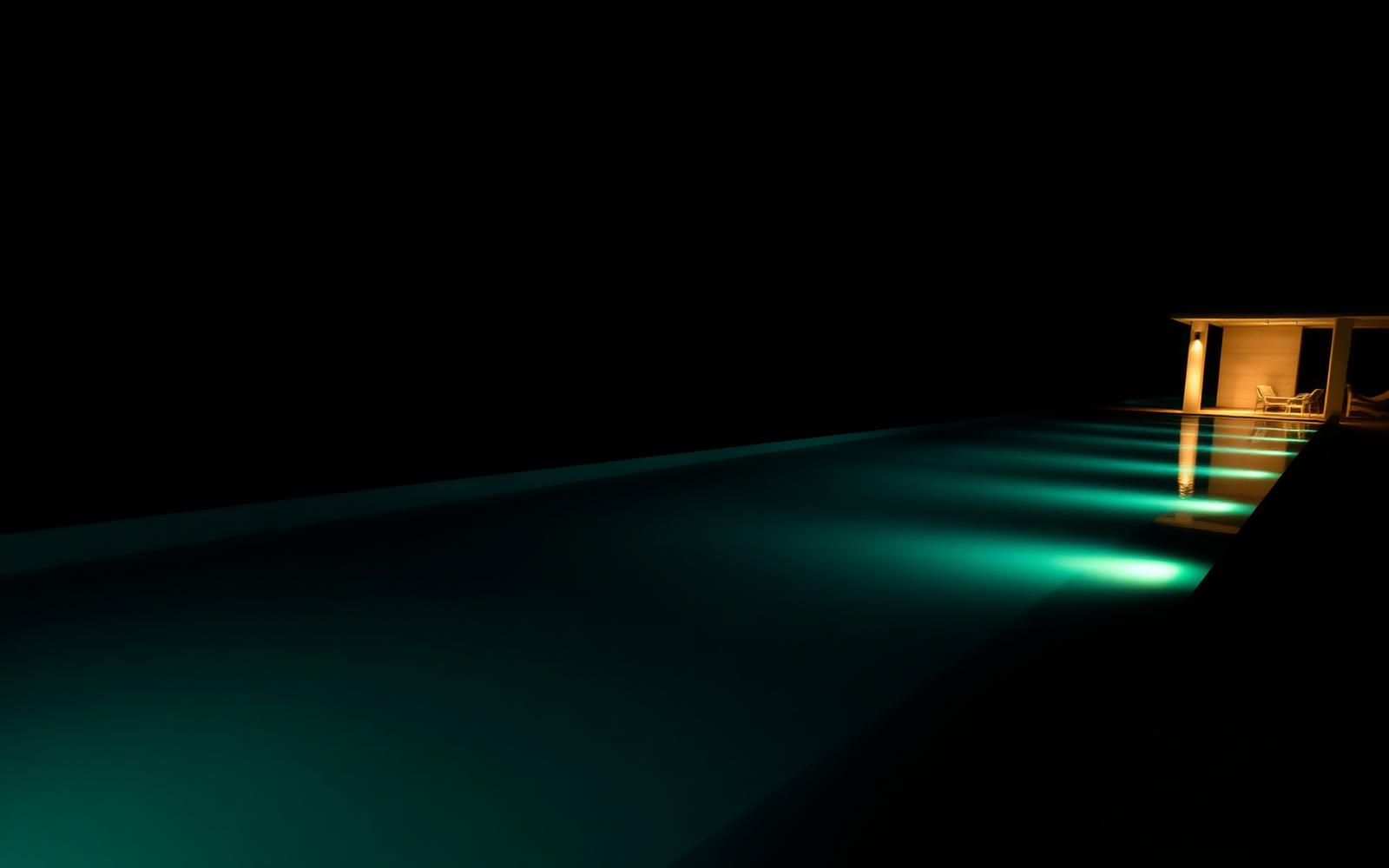 Illuminated infinity pool at night